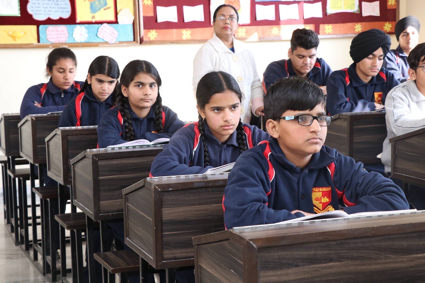 Students working attentively at their desks during a lesson